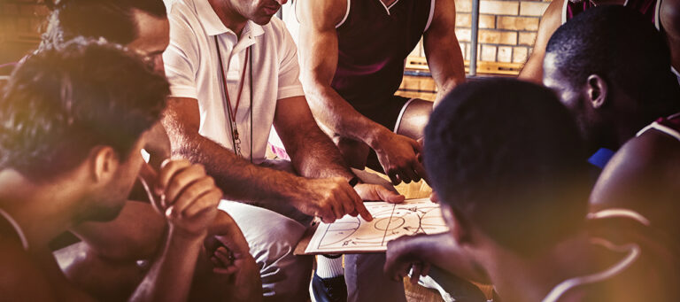 Coach explaining game plan to basketball players