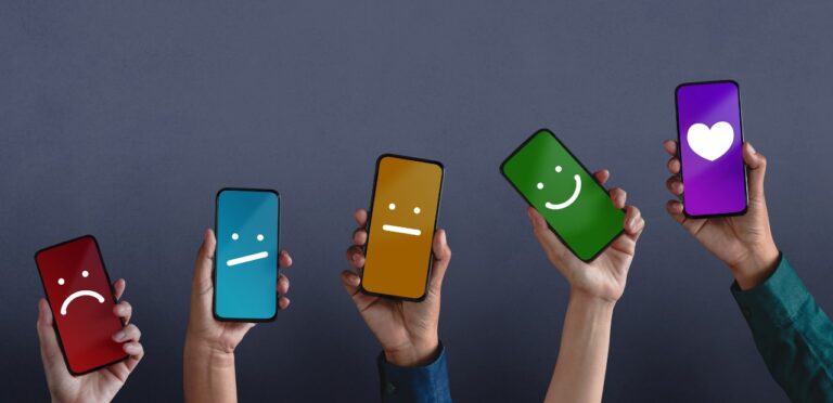 a row of five phones each displaying a different emoji face representing a reaction. The faces are, from left to right: displeased, somewhat displeased, neutral, somewhat pleased, and pleased.