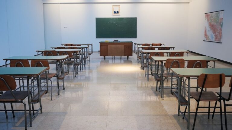 image of a classroom with two columns of desks leading to the front.