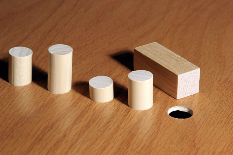 Blocks illustrating trying to fit a square peg in a round hole