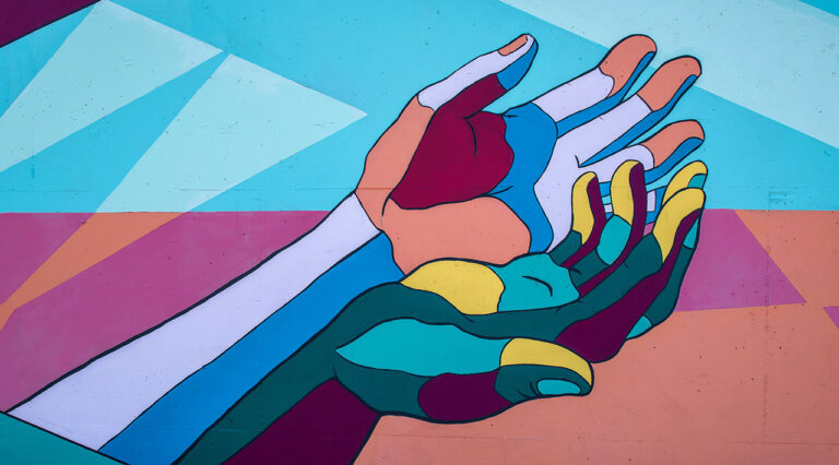 A photo of a painted mural of colorful hands