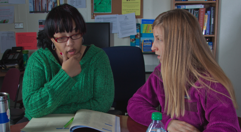 Lauren Divine, right, a tutor with UAF's Student Support Services, works with Sante Lee-Sonkoh during a session in the SSS study lounge in the Gruening Building.