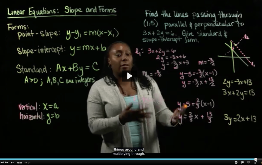 Latrice Bowman standing behind a Learning Glass, writing MATH instruction.