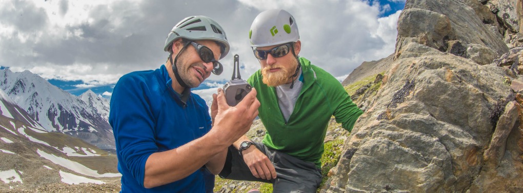Geophysical Institute research professor Jeff Benowitz shows undergraduate Pat Terhune how to use a geologic compass on a rock outcrop near their camp above the Chedotlothna Glacier